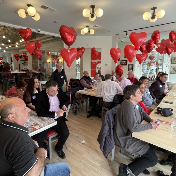 Networking event photo of people sitting at tables and chairs